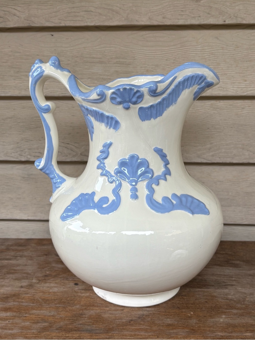 VTG ceramic pottery pitcher is crafted in a cream-white glaze